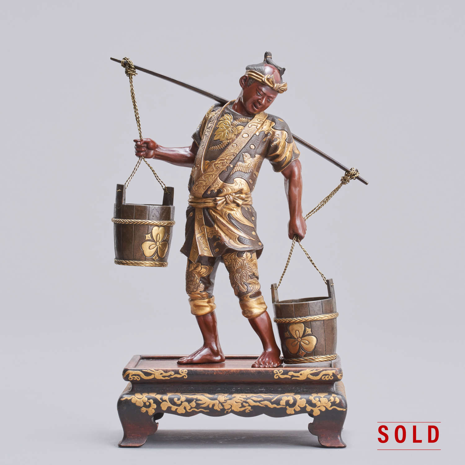 Japanese bronze man carrying water signed Miyao Meiji period