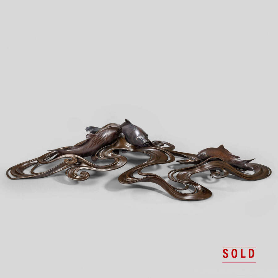 Japanese bronze of koi carps swimming through waves signed Ōshima Joun Meiji period